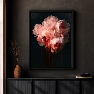 May include: A framed rectangular wall art piece featuring a cluster of pale pink peony flowers against a solid black background. Bright red paint appears to drip vertically from the base of the floral arrangement down the dark canvas.