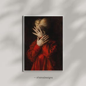May include: A framed art print featuring a person in a red garment, with hands covering the face. The artwork has a dark, dramatic aesthetic, with a focus on the hands and the texture of the fabric. The artist's name, -ATeinaDesigns, is at the bottom.