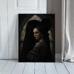 May include: A framed wall art print featuring a dark, moody portrait of a person with dark hair wearing a textured, ruffled garment. Behind them stands a shadowy, fur-clad figure. The background shows a dim, arched window with a diamond grid pattern.