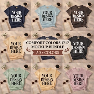 May include: A selection of Comfort Colors 1717 t-shirts in shades like navy, pale blue, brown, beige, dark grey, sage green, yellow, and pink. Each tee displays "YOUR DESIGN HERE". The image also features coffee cups, books, and sunglasses. The shirts are in various sizes.