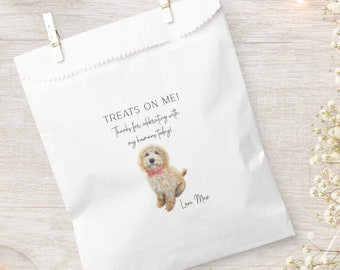 May include: White paper bag with a scalloped edge, featuring a watercolor illustration of a dog wearing a red bow tie. The text reads "Treats on me! Thanks for celebrating with my humans today! Love, Max".
