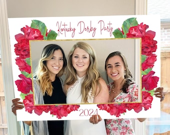 May include: A white photo booth prop with a gold frame and red floral accents. The text "Kentucky Derby Party 2024" is printed on the prop.