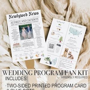 May include: A wedding program fan kit with a two-sided printed program card, six glue dots, and a wooden handle. The program card features a newspaper-style design with the headline "Newlywed News" and the text "Audrey and Jackson are getting married today!" The back of the card features a map of the United States with a heart over St. Lucia, a photo of a couple with their dogs, and a QR code. The program card is printed on white cardstock with black text and images.