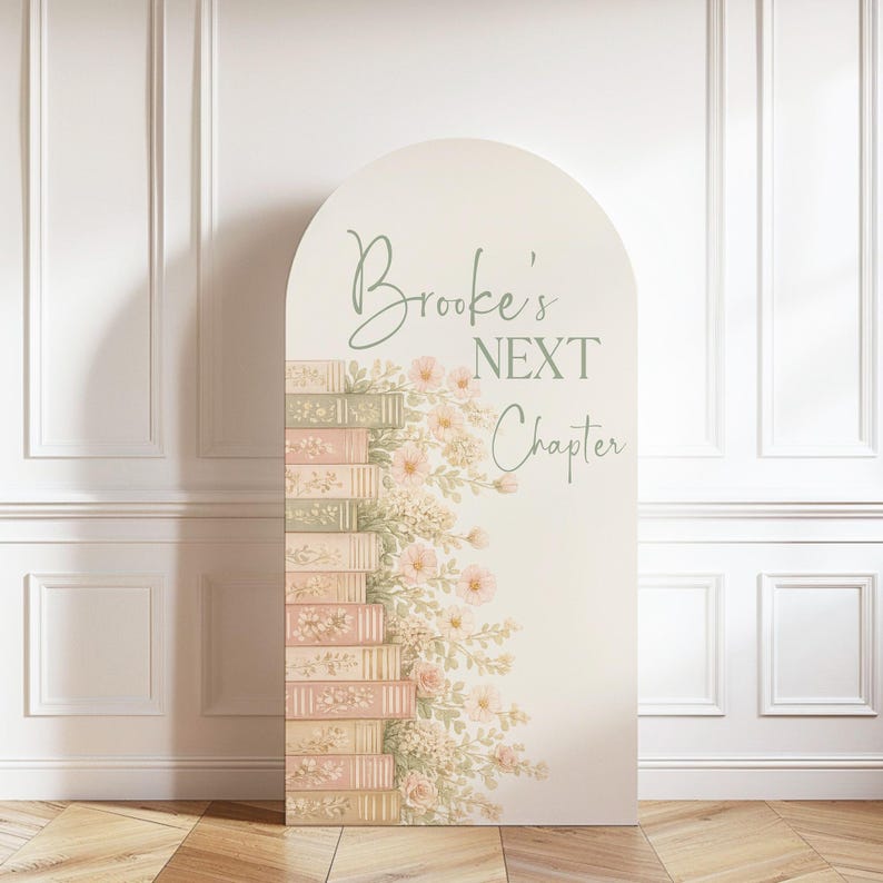 May include: An arched sign featuring a stack of illustrated books in shades of cream, pink, and sage green, adorned with delicate floral vines. The text "Brooke's NEXT Chapter" is printed in a sage green script and serif font on the cream background.