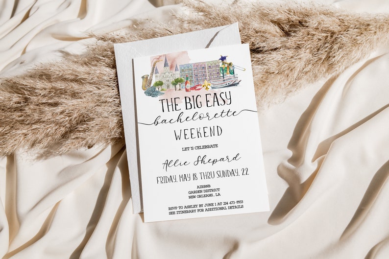 May include: A white card with black text announcing a bachelorette weekend in New Orleans, Louisiana. The card features a watercolor illustration of a cityscape with a steamboat, a saxophone, and a building with a fleur-de-lis. The text reads "The Big Easy Bachelorette Weekend Let's Celebrate Allie Shepard Friday, May 18 thru Sunday 22.  Address Garden District New Orleans, LA RSVP to Ashley by June 1 at 504-473-9993 See Itinerary for Additional Details"