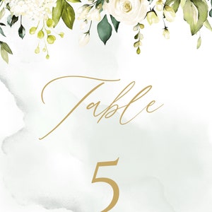 May include: White floral wedding table number card with a gold script font that says "Table 5".