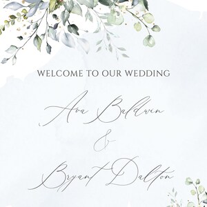 May include: A wedding invitation with a watercolor background featuring a floral design in shades of blue and green. The text reads "Welcome to our wedding Ava Baldwin & Bryant Dalton The 18th of September, 2019".