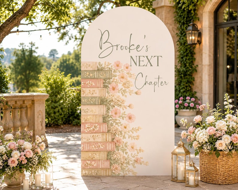 May include: An arched white event sign featuring the text Brooke's NEXT Chapter in gray script and block lettering. The left side displays a vertical stack of illustrated books in muted pink and green tones, accented with soft pink floral vines.