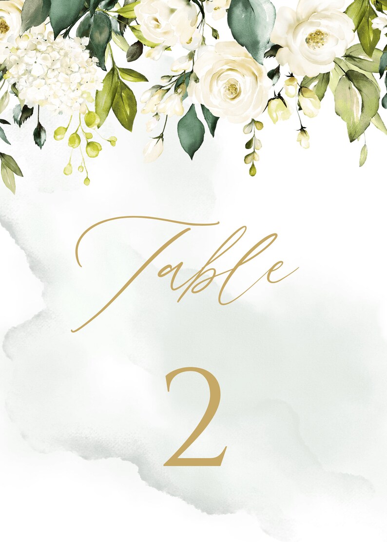 May include: White floral wedding table number card with gold calligraphy that says "Table 2" on a light green watercolor background.
