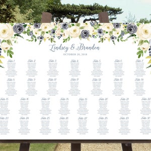 May include: A wedding seating chart with a floral design featuring white and blue flowers. The chart lists tables 1 through 30 with guest names. The text at the top reads "Lindsey & Brandon" and "October 20, 2018".