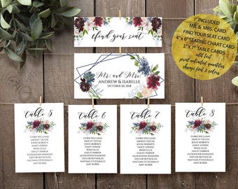 May include: A set of wedding stationery including a Find Your Seat sign, a Mr. and Mrs. sign with the text Andrew & Isabelle October 20, 2018, and four table cards labeled 5 through 8, all featuring burgundy and blue floral accents.