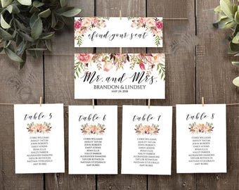 May include: A set of white wedding seating chart cards and signs featuring floral illustrations in pink, peach, and green. The text includes "find your seat," "Mr. and Mrs. BRANDON & LINDSEY MAY 24, 2018," and "table 5," "table 6," "table 7," and "table 8."