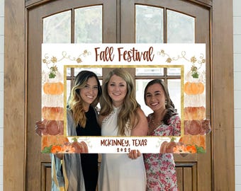 May include: A rectangular photo booth frame featuring a white background with watercolor pumpkin illustrations on the sides. The top text reads Fall Festival in brown script, and the bottom text reads MCKINNEY, TEXAS 2022 in black font.
