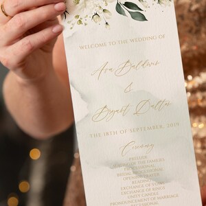 May include: Wedding ceremony program with white flowers and green leaves on a watercolor background. The program lists the order of events for the wedding of Ava Baldwin and Bryatt Dalton on September 18, 2019.