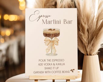 May include: A rectangular sign titled Espresso Martini Bar featuring a watercolor illustration of a cocktail glass with a beige ribbon bow, topped with coffee beans, and instructions to pour espresso, add vodka and Kahlua, shake, and garnish.