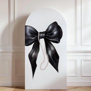 May include: A large, black bow with a pearl necklace hanging from the knot is painted on a white, arched background. The bow has long, flowing tails and is centered on the canvas. The pearls are a soft, off-white color.