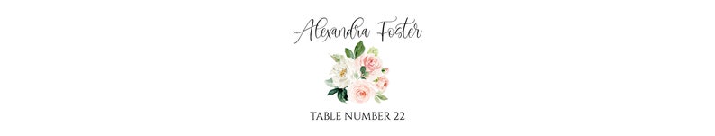 May include: A floral table number card with a white background. The card features a bouquet of pink and white flowers with green leaves. The text "Alexandra Foster" is written in cursive at the top of the card. The text "TABLE NUMBER 22" is written in black at the bottom of the card.