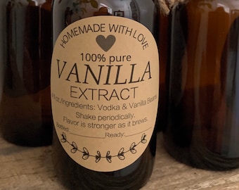 May include: Four brown glass bottles of vanilla extract with black caps and twine tied around the necks. Each bottle has a label that reads "Homemade with Love" and "100% pure VANILLA EXTRACT". The label also lists ingredients and instructions.