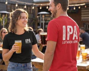May include: A black t-shirt with white text reading IPA LOT WHEN I DRINK and a red t-shirt with white text reading IPA LOT WHEN I DRINK. Both shirts feature short sleeves and a crew neckline, worn with blue denim jeans while holding beer glasses.