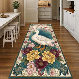 May include: A rectangular runner rug featuring a white duck with orange feet and beak, surrounded by yellow, pink, and burgundy flowers. The rug has a teal background and a decorative border, suitable for a hallway or entryway.