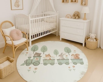 May include: A round, off-white rug with a whimsical train design. The train cars are light green and carry a bear, fox, rabbit, and squirrel. Green trees and small flowers surround the train. The rug is in a nursery setting with a crib and chair.