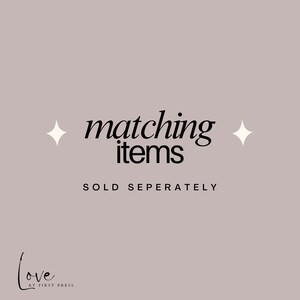 May include: A light mauve graphic with black text that reads matching items, followed by the text SOLD SEPERATELY in all capital letters. Two white four-pointed star icons are positioned on either side of the main text. The logo Love AT FIRST PRESS is in the bottom left corner.