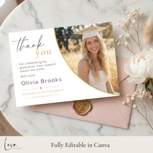 May include: A graduation thank you card with a photo of a smiling graduate wearing a cap. The card features gold accents and the text "thank you" and "Olivia Brooks, Alabama State University, Class of 2026". A pink envelope and wax seal are also visible.