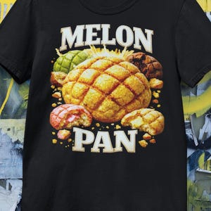May include: Black t-shirt featuring a graphic of several melon pan pastries. The design includes a large, golden-brown melon pan with a grid pattern, surrounded by smaller, colorful versions and the text "MELON PAN" in white.