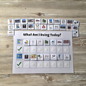 May include: A white visual schedule board titled What Am I Doing Today? with rows for morning and evening routines. It features colourful activity icons for tasks like breakfast, school, and sleep, accompanied by a collection of loose square activity cards.
