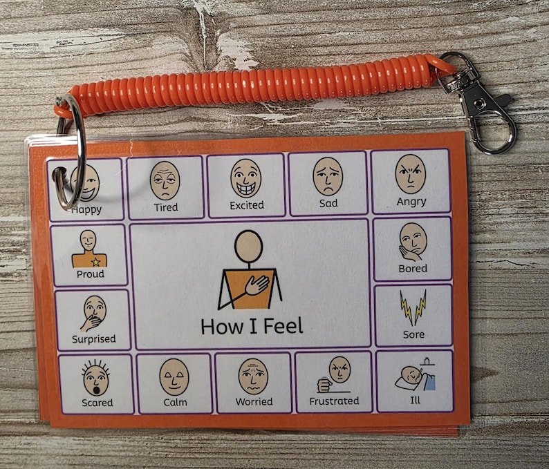 May include: A rectangular communication card set titled How I Feel, featuring twelve illustrated facial expressions labeled Happy, Tired, Excited, Sad, Angry, Proud, Bored, Surprised, Sore, Scared, Calm, Worried, Frustrated, and Ill, attached to an orange coil.