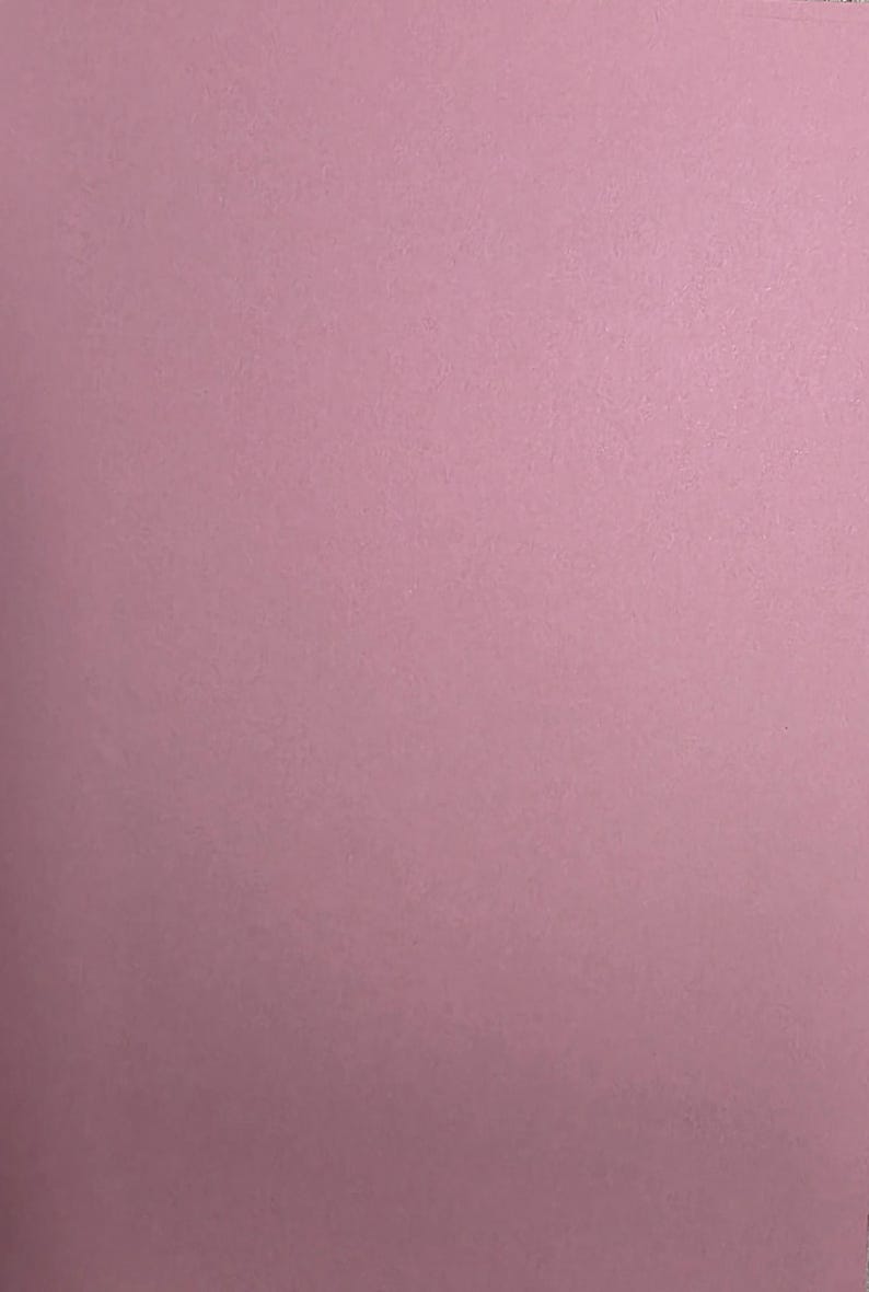 May include: A solid sheet of matte paper in a soft, muted dusty rose pink color. The surface has a fine, uniform texture throughout, displaying a consistent, flat, and opaque appearance without any patterns, designs, or additional markings.