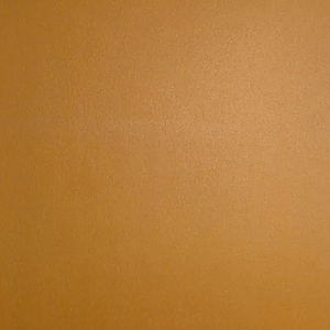 May include: A solid, uniform sheet of paper or cardstock with a smooth, matte texture in a warm, medium-toned golden brown or ochre color. The surface is consistent throughout, displaying no patterns, markings, or additional features across the frame.