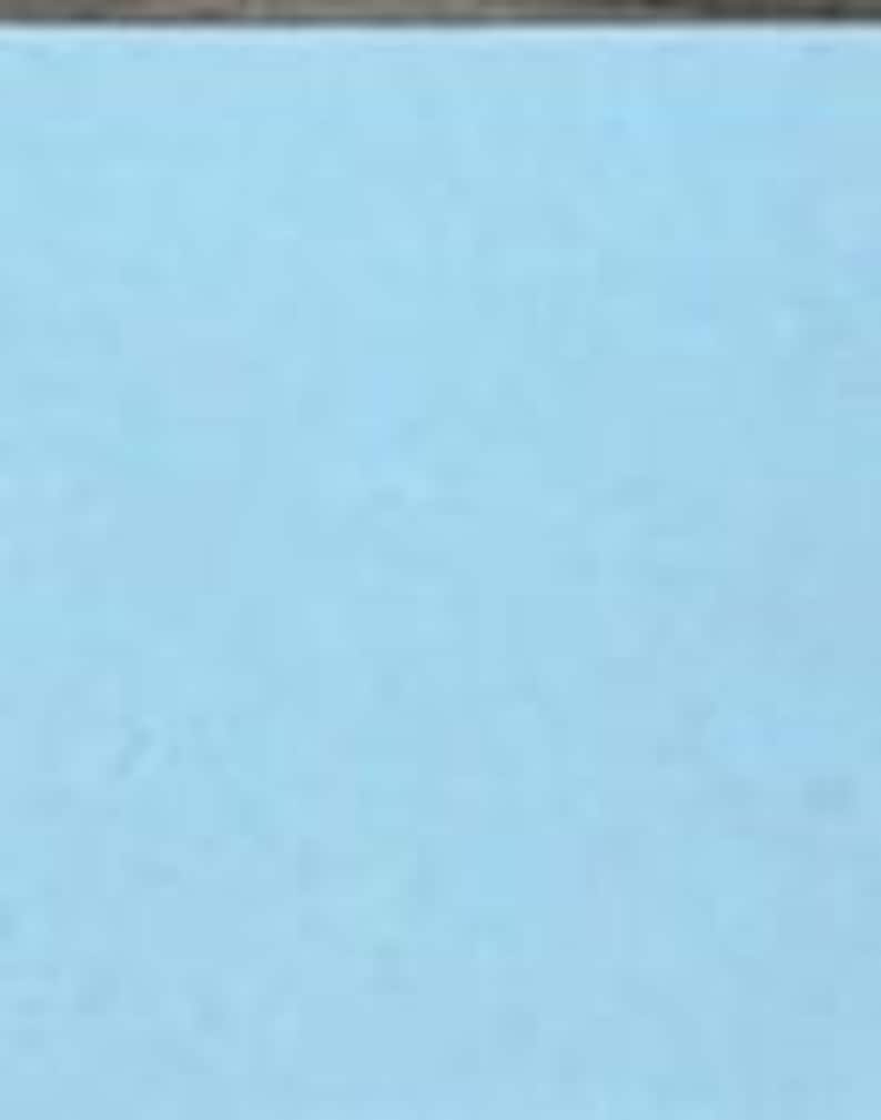 May include: A solid, light blue rectangular surface with a smooth, matte texture. The color is a consistent, uniform shade of sky blue that covers the entire visible area, providing a clean and simple background with no patterns or additional details.