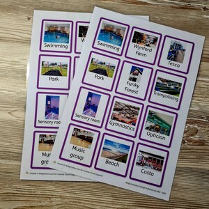 May include: Two sheets of printed cards with purple borders and various images. Each card has a label, including "Swimming," "Park," "Sensory room," "Music group," "Beach," and "Costa." The cards are on a wooden surface.