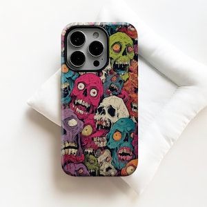 May include: A phone case with a colourful design of cartoon zombie skulls. The skulls are in various colours, including pink, green, blue, and purple, with detailed facial features. The case has a glossy finish and a camera cutout.