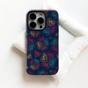 May include: A navy blue phone case featuring a repeating pattern of colorful heart shapes. The hearts are filled with intricate, swirling designs in shades of yellow, pink, teal, and orange. The case has a glossy finish.