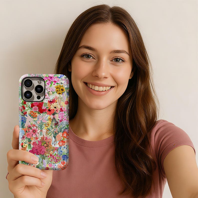 May include: A floral patterned phone case featuring a vibrant mix of red, pink, yellow, and blue flowers. The case has a white background and a glossy finish, offering a stylish and protective accessory for a smartphone.