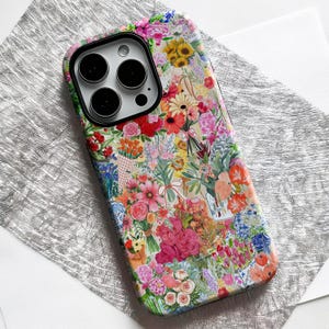 May include: A colorful phone case featuring a vibrant floral design. The case is covered in a collage of various flowers in shades of pink, red, yellow, and blue. The case has a camera cutout with three lenses.