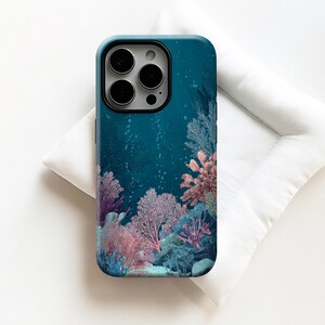 May include: A smartphone case featuring a deep teal underwater scene with light pink and purple coral formations, intricate sea fan structures, and small rising air bubbles. The design covers the back of the case, surrounding the camera lens cutout.
