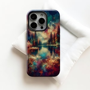 May include: A phone case featuring a colorful landscape design. The artwork depicts a serene lake scene with trees, reflections, and a vibrant sky. The case has a black border and a glossy finish, offering protection and style.
