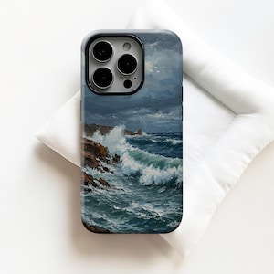 May include: A phone case featuring a seascape painting with crashing waves, rocky cliffs, and a stormy sky. The case has a black border and a glossy finish, offering protection and artistic flair.