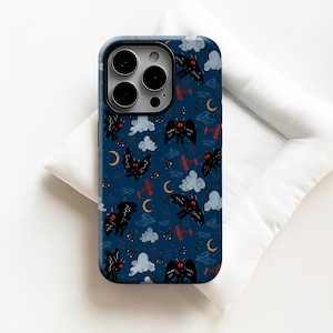 May include: A dark blue phone case featuring a repeating pattern of black moths, white clouds, red accents, and yellow crescent moons. The case has a glossy finish and is designed for a smartphone.