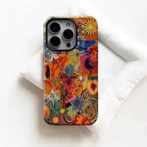 May include: A colorful phone case with a collage design. The case features a mix of images including stars, moons, flowers, and black cats. The color palette includes orange, yellow, blue, and pink.