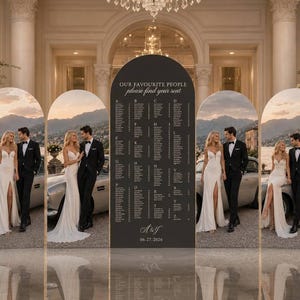 May include: A dark grey arched seating chart sign with white text reading "OUR FAVOURITE PEOPLE please find your seat" and "A&F 06.27.2026" flanked by four arched panels displaying a couple in formal attire standing by a vintage car.