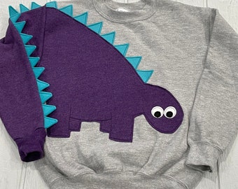 CLEARANCE Youth dinosaur shirt with purple dinosaur with teal spikes. Size youth medium FREE US Shipping