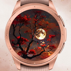 May include: A rose gold smartwatch with a light pink band. The watch face displays a vibrant scene of a tree with red leaves, a full moon, and a cloudy sky. The text "In Bloom Babe" is at the top.