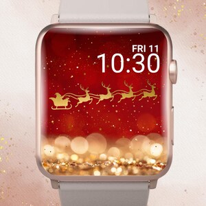 Op de afbeelding: Een smartwatch met een kerstthema. De wijzerplaat toont een rode achtergrond met een gouden ontwerp van de kerstman en rendierslee, de tijd 10:30 uur en de datum Vr 11. Het horloge heeft een lichtgrijze band en een goudkleurige behuizing.