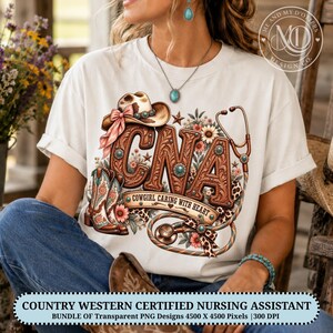 May include: A white t-shirt featuring a graphic design with the letters CNA in a brown leather-like texture, a cowboy hat with a pink ribbon, a stethoscope, cowboy boots, and floral accents. The text reads COWGIRL CARING WITH HEART.
