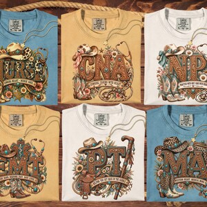 May include: Six t-shirts in blue, tan, and white featuring western-themed medical graphics. Each shirt displays a unique acronym like NURSE, CNA, NP, EMT, PT, or MA, decorated with cowboy hats, boots, stethoscopes, and floral elements.