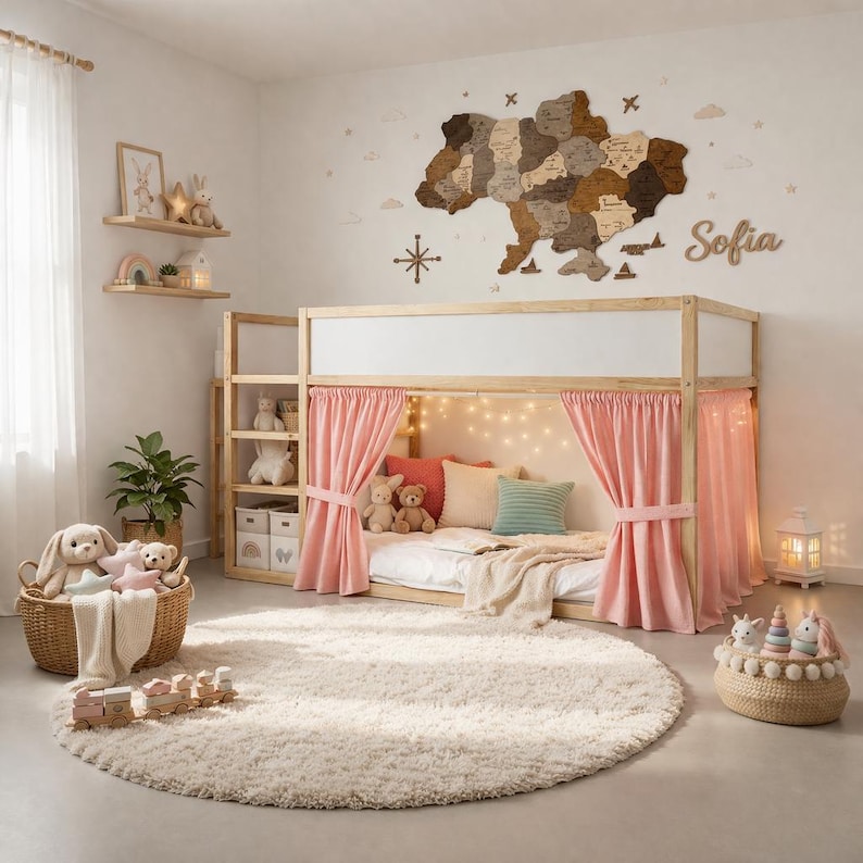 May include: A light wood bunk bed with pink curtains and a fluffy white rug. The wall features a wooden map and the name "Sofia". The room is decorated with stuffed animals, pillows, and a woven basket.